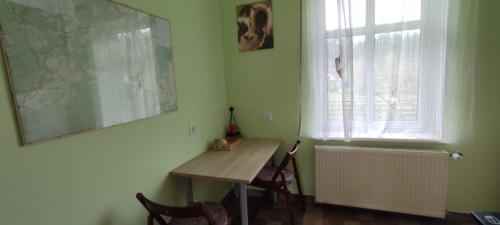 a table and chairs in a room with a window at Zacisze Pod Bukami in Górnica