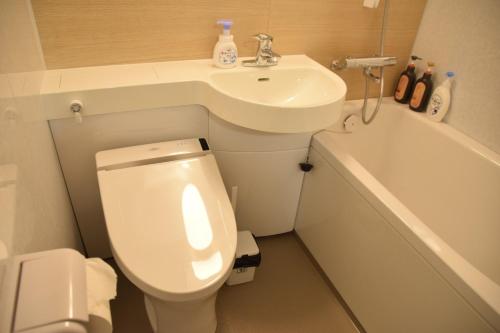 a small bathroom with a toilet and a sink at 伯方plus+ in Imabari