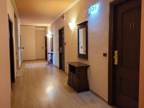 a hallway with a door and a mirror on a wall at Locanda San Pietro in Preturo