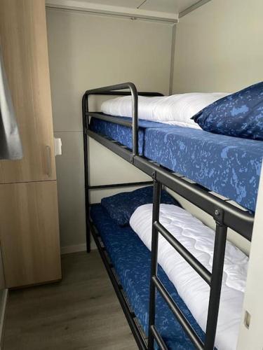 a couple of bunk beds in a room at Houseboot Kingfisher, lake view in Biddinghuizen