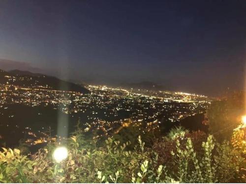 a view of a city at night with lights at IL PANORAMA in Altofonte