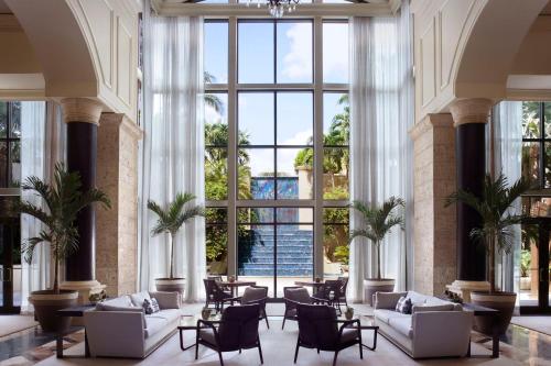 a lobby with white furniture and large windows at The Ritz-Carlton Coconut Grove, Miami in Miami