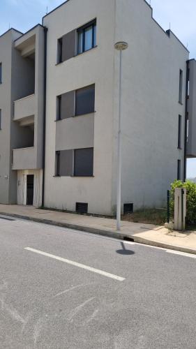 an empty street in front of a building at The Apartments in VALAMAR in Hamallë