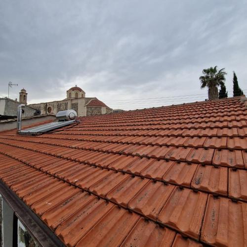 a red tile roof on a building at THE ROCK HOUSE - Beautiful countryside with mandarins oranges and olive trees,. Near Limassol at Eptagonia village. in Ephtagonia