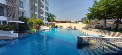 a swimming pool with blue water in a building at Tira Tiraa Condominium in Hua Hin