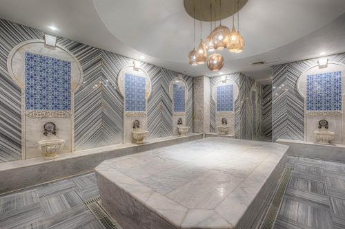 a large room with three sinks and a large table at WELL PALACE SIDE in Side