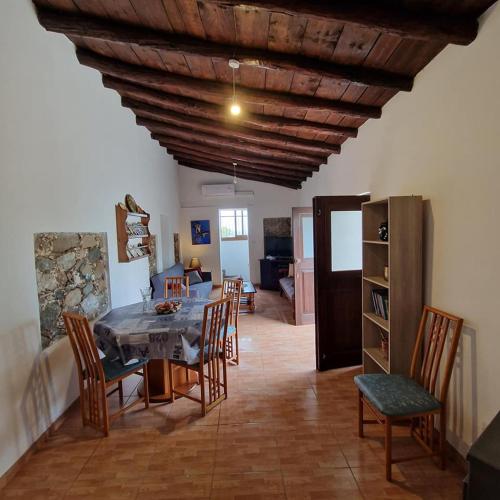 a kitchen and dining room with a table and chairs at THE ROCK HOUSE - Beautiful countryside with mandarins oranges and olive trees,. Near Limassol at Eptagonia village. in Ephtagonia