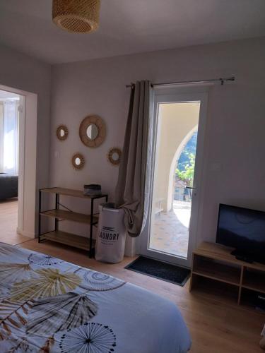 a bedroom with a bed and a sliding glass door at Appartement sur Vals les bains in Vals-les-Bains