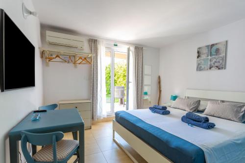 a bedroom with a bed with two blue shoes on it at Apartments Tamaris in Malinska