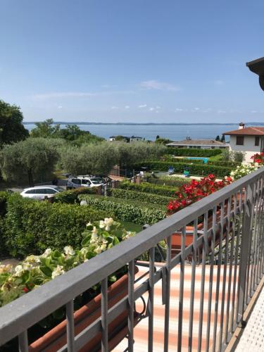 een balkon met uitzicht op een tuin bij Appartamenti Villafiorito in Lazise