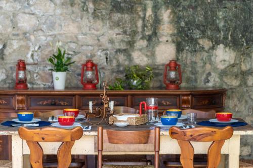 a table with chairs and a table with food on it at Sleep In Venzone in Venzone