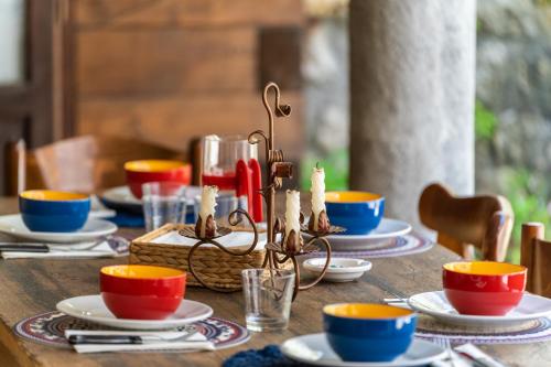 a wooden table with plates and cups on it at Sleep In Venzone in Venzone