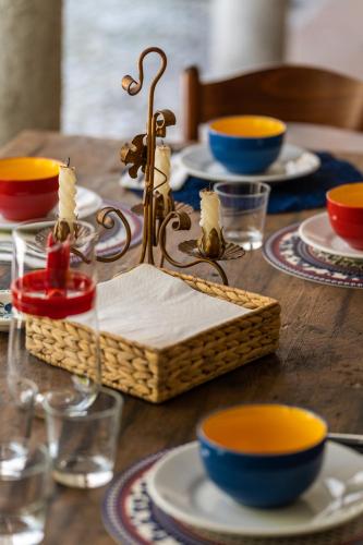 a table with plates and bowls and a basket on it at Sleep In Venzone in Venzone