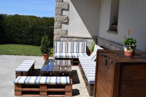 a patio with two chairs and a table and a table and chairs at Casa Rural Galain Ultzama-Navarra in Lizaso