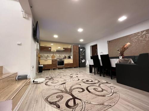 a kitchen and dining room with a rug on the floor at Casa Sofia in 2 Mai