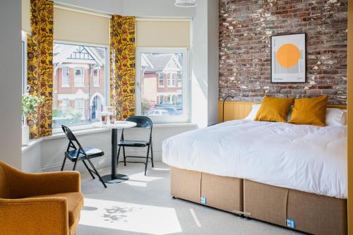 um quarto com uma cama, uma mesa e cadeiras em Settle in Southampton - Self Check-In Serviced Rooms & Suites em Southampton