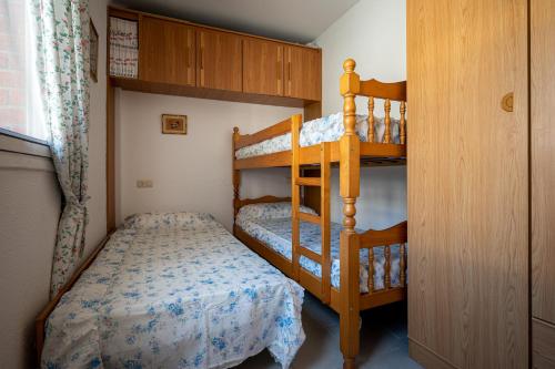 a bedroom with two bunk beds and a bed at AT097 Torrepark in Torredembarra