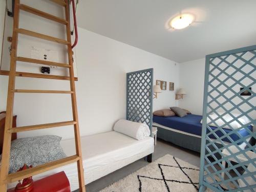 a bedroom with a bunk bed and a ladder at PARIS AUTHENTIC HOUSE, Entier 1920's villa métro Line 7 in Paris