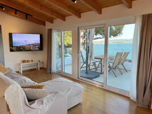 a living room with a couch and a view of the ocean at Osservatorio House in Laganas