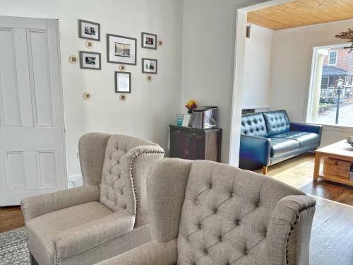a living room with a couch and a chair at Inn at the Falls in Bracebridge