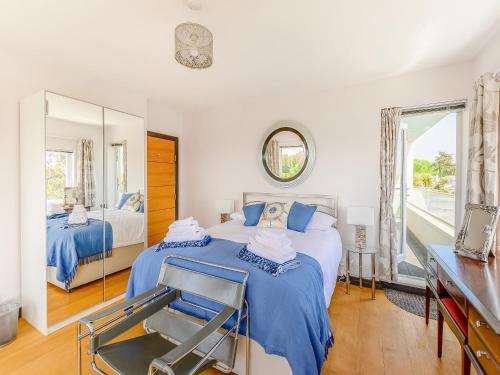 a bedroom with two beds and a mirror at Three Decks in Yapton