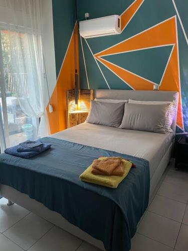 a bedroom with a bed with a towel on it at Seaside apartment in Athens