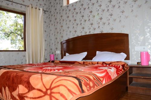 a bedroom with a large bed and a window at Bhandari Homestay and Restaurant in Mussoorie