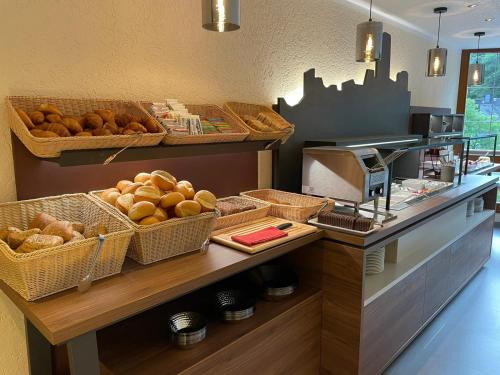 a bakery with baskets of bread and a counter at Hotel Burgfrieden in Beilstein