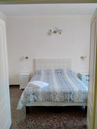 a bedroom with a bed with a book on it at Affittacamere DA MARIA TERESA in Sestri Levante