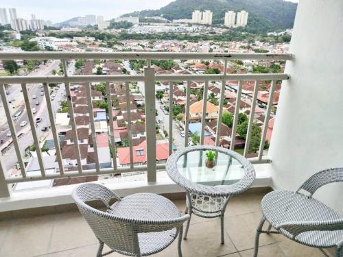 a balcony with chairs and a table and a view at Comfy Home Near to SPICE and USM in Bayan Lepas