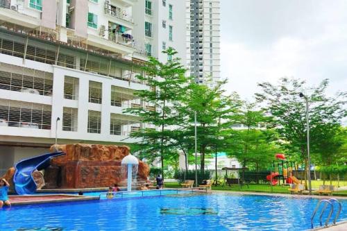 a large swimming pool in front of a building at Comfy Home Near to SPICE and USM in Bayan Lepas