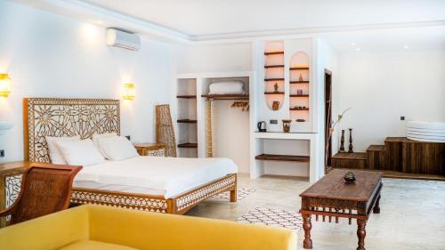 a bedroom with a bed and a couch and a table at Almina Garden Boutique in Bodrum City