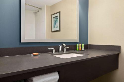 a bathroom with a sink and a mirror at Wyndham Garden Niagara Falls Fallsview in Niagara Falls