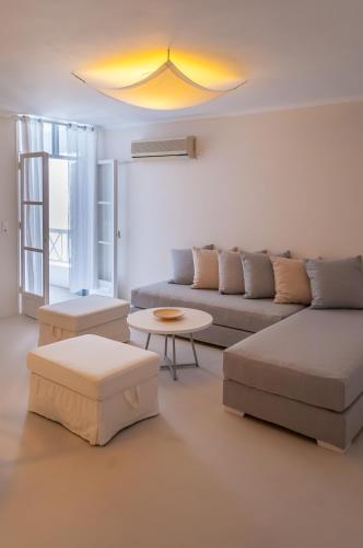 a living room with a couch and a table at Milos Bay Suites in Adamas