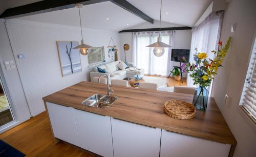 a kitchen with a counter top and a living room at Unieke woonboot in Harlingen in Harlingen