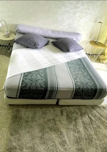 a bed with two pillows on it in a room at Appartement RIM in Casablanca