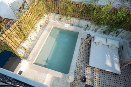 an overhead view of a swimming pool with a tiled floor at Riad Zhor Tanger - Médina in Tangier