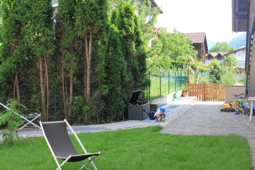 a yard with two chairs and a tv in the grass at Kehrerhof in Rifiano