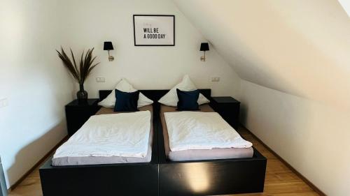a bedroom with two beds in a attic at Rheinländer Seehotel in Leverkusen