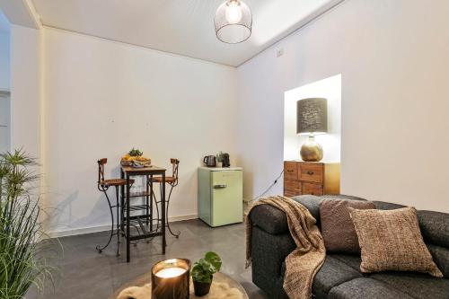 a living room with a couch and a table at Charming getaway in the historical city center in Bruges