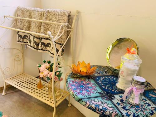 a room with a table with a mirror and a shelf at Bells Meadow Shepherds Hut in Kings Lynn