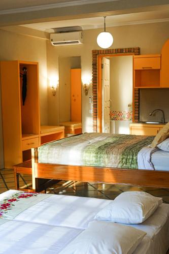 a hotel room with two beds and a bathroom at Hotel Deli River and Restaurant Omlandia in Medan
