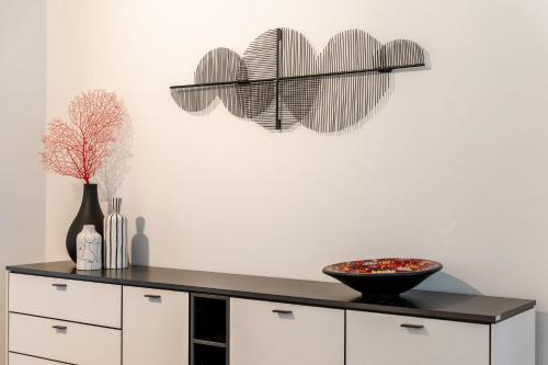 a kitchen with a black counter top with a bowl on it at Brand new holiday home with high-end finishing and private parking space, at a stone's throw from the beach in Ostend