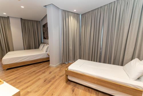 Postel nebo postele na pokoji v ubytování Titania Hotel