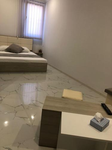 a bedroom with a bed and a marble floor at Village Jazz in Chimankend