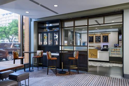 a restaurant with chairs and a bar in a building at JW Marriott Houston by the Galleria in Houston