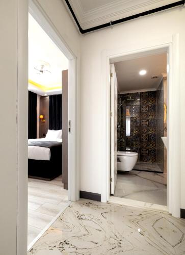 a room with a bathroom with a tub and a bedroom at Selia SUİTES in Trabzon