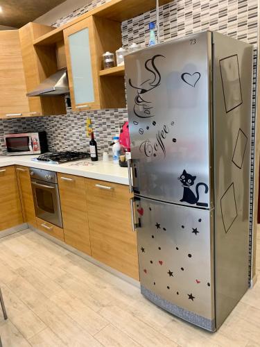 a kitchen with a refrigerator with a cat on it at Appartamento La Casa di Anna in San Severo