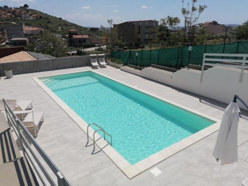 a swimming pool on the roof of a building at Casa Vacanze Villa Tropia in Camastra ex Solfara