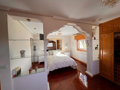 a bedroom with a bed and a room with a window at Villa overlooking Cies Islands in Vigo